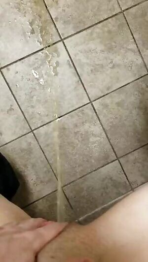 spraying down the restroom floor