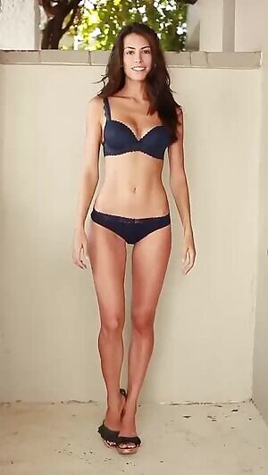 Skinny brunette in blue lingerie kiss and wave