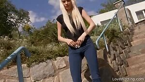 Sexy blonde unbuttons her jeans, pulls them down, and pisses through her clothes