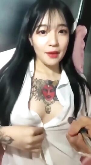 Showing off her tat and tits