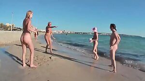 4 nude girls playing ball on a non-nude beach