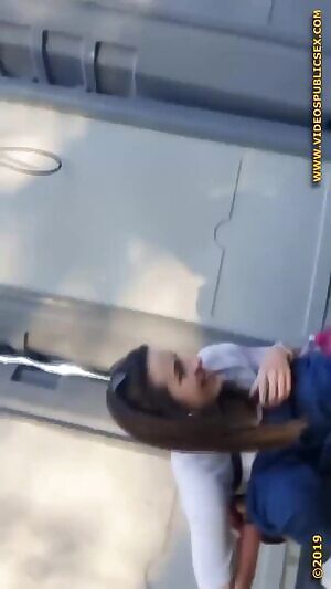 Festival girl squats down behind porta potty’s and pees forcefully into the grass