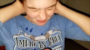 Big load on her face and shirt - keep watching for 2nd set of spurts