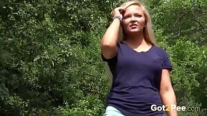 Gorgeous blonde Jena Lovely takes off her shorts to pee on a woodland path